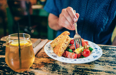 Person eating food at a dining table