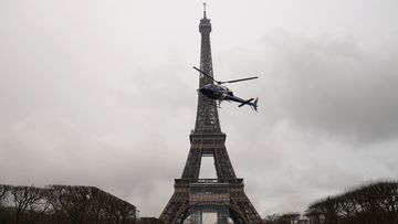 A Eurocopter Ecureuil 2 helicopter installs a new telecom transmission TDF (TeleDiffusion de France) antenna on the top of the Eiffel Tower. 