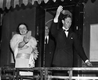 The Queen Mother and King George VI waving to the crowd
