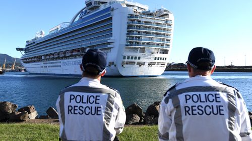 NSW Police Rescue officers look on as the Ruby Princess, with 1040 crew on board, docks at Port Kembla, Wollongong