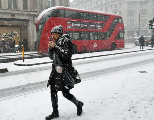 A pedestrian braves the snow in Oxford Street, central London. (AP).