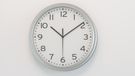 Clock on white wall in office