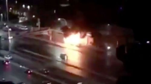 A bus appears engulfed by flames on Sydney Harbour Bridge.