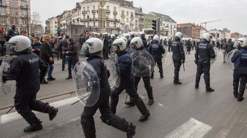 Riot police secure a zone in the Molenbeek neighborhood in Brussels. (AAP/ Olivier Matthys)