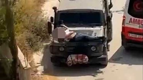An injured Palestinian man is seen strapped to the hood of an Israeli military jeep in a video screengrab on June 22, 2024. 