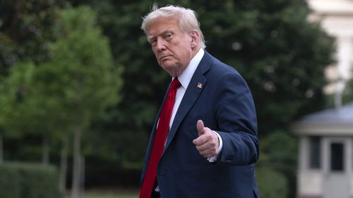 President Donald Trump gives a thumbs up to reporters as he walks on the South Lawn upon arriving at the White House, Sunday, July 13, 2025, in Washington. (AP Photo/Jose Luis Magana)