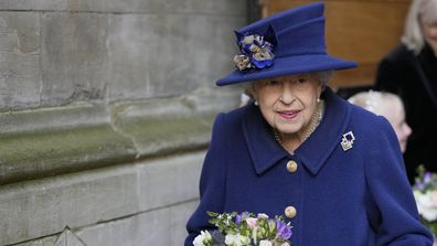 Britain's Queen Elizabeth II, Patron, holds flowers as she leaves after attending a Service of Thanksgiving to mark the Centenary of the Royal British Legion at Westminster Abbey, in London, Tuesday, Oct. 12, 2021. (AP Photo/Frank Augstein, Pool)