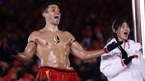 Despite the one degree Celsius temperatures in the stadium, the famous Tongan flagbearer Pita Taufatofua went shirtless again, however, this time he opted for gloves. (AAP)