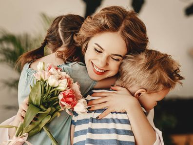 Children give their mother flowers on Mother's Day