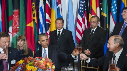 Mr Obama and Mr Putin share an uncomfortable toast. (AAP)