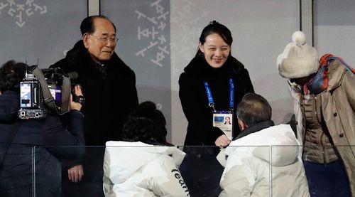 South Korean President Moon Jae-in, bottom right, shakes hands with North Korean leader Kim Jong Un's younger sister Kim Yo Jong during the opening ceremony. (AAP)