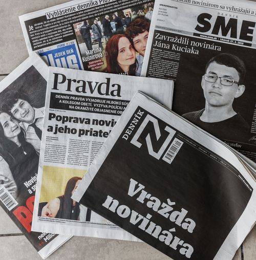 Picture taken near the village of Velka Maca, Slovakia, Tuesday, Feb. 27, 2018, shows front pages of various Slovakian newspapers reflecting on murder of Slovak investigative journalist Jan Kuciak and his girlfriend Martina Kusnirova. Slovakia's top police officer Tibor Gaspar said the investigative reporter has been shot dead in his home in Velka Maca together with his girlfriend. Kuciak specialized in investigating tax evasion. The headline, down right, reads: "Murder of Journalist." (Michal Smrcok/News and Media Holding via AP)