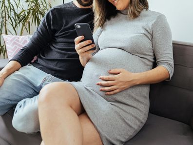 Pregnant couple on a couch