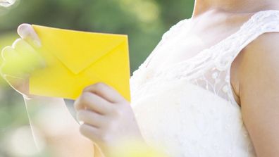 Bride holding invitation