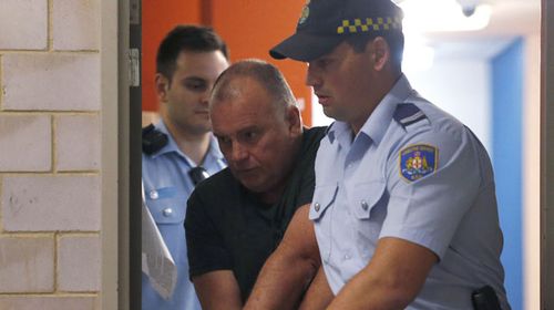 Former NSW police detective Glen McNamara is escorted by Corrective Services officers. (AAP)