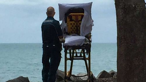 The paramedic taking the patient to see the ocean. (Facebook/Queensland Ambulance)