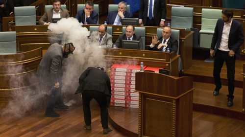 Despite the use of the tear gas, the Kosovo parliament ultimately passed the bill 80-11 with the minimum two-thirds required. Picture: AAP.