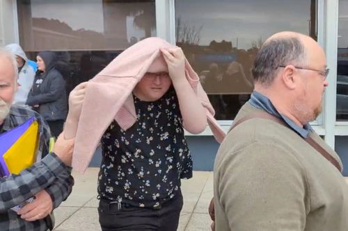 Birdie Kingston covering her face after her case was briefly heard at Penrith Local Court in Sydney, Friday, July 18, 2025.