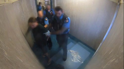 During one incident at Hakea Prison in March 2016, a prisoner is taken into a cell for a strip search. Picture: 9NEWS