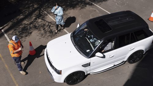 A car departs the new drive-through vaccination clinic at Belmore Sports Ground in Sydney.