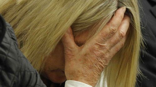The mother of Reeva Steenkamp, June Steenkamp, hides her face as she listens to Oscar Pistorius detail the night he shot her daughter to death. (Getty)