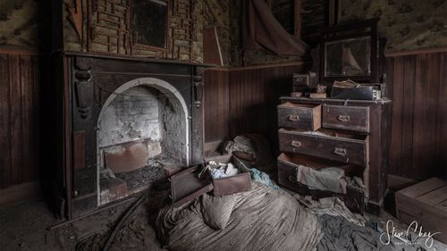 A half-packed suitcase sits on top of what appears to be some bedding.