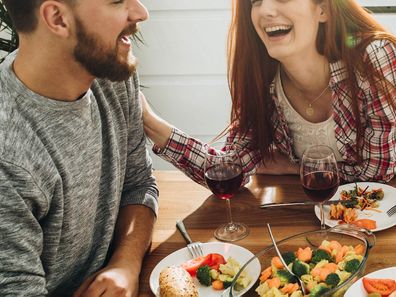 Two friends chatting over dinner