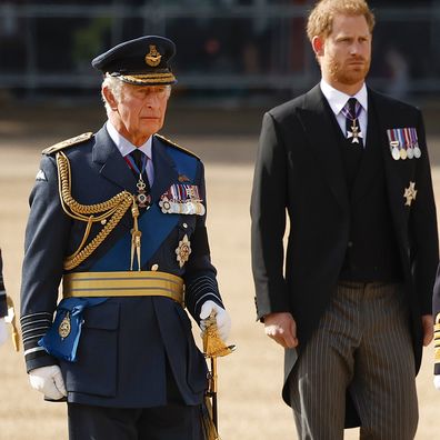 Prince William, Prince of Wales, King Charles III and Prince Harry, Duke of Sussex walk behind the coffin during the procession for the Lying-in State of Queen Elizabeth II on September 14, 2022 in London, England.  