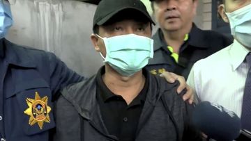 In this image taken from video, Lee Yi-hsiang, the driver of the truck that caused the train accident , offers a public apology as he is led by police in Hualien, Taiwan. 