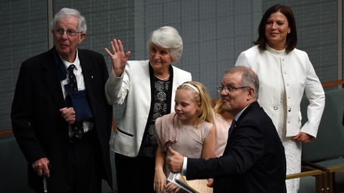 The treasurer gives the thumbs-up surrounded by members of his family. (AAP)