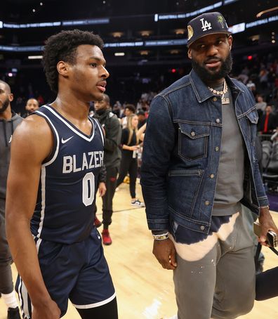 PHOENIX, ARIZONA - DECEMBER 11: Bronny James #0 of the Sierra Canyon Trailblazers and father LeBron James of the Los Angeles Lakers walk off the court following the Hoophall West tournament at Footprint Center on December 11, 2021 in Phoenix, Arizona. (Photo by Christian Petersen/Getty Images)