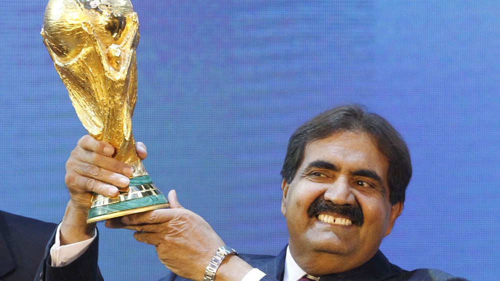 Sheikh Hamad bin Khalifa Al-Thani, Emir of Qatar, holds the World Cup trophy after the announcement of Qatar hosting the 2022 soccer World Cup.(AAP)