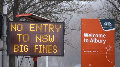 A sign is displayed regarding COVID-19 restrictions in the New South Wales (NSW), Victoria border town of Albury on July 7, 2020 in Australia.