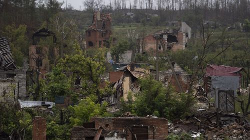 Destroyed houses can be seen in the recaptured village of Bohorodychne, eastern Ukraine, Friday, September 23, 2022. (AP Photo/Leo Correa)