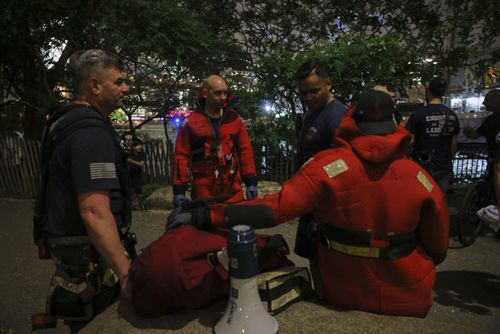 New York Fire Department divers prepare to dive the East River after a masted Mexican Navy training ship collided with the Brooklyn Bridge.