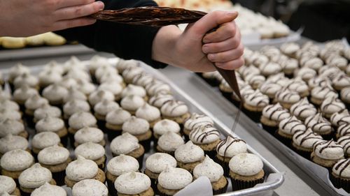 Ms Matheson at work on some chocolate-drizzled mini cupcakes.