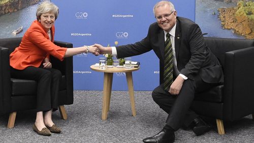 Mr Morrison and Mrs May shook hands after they met for face-to-face talks