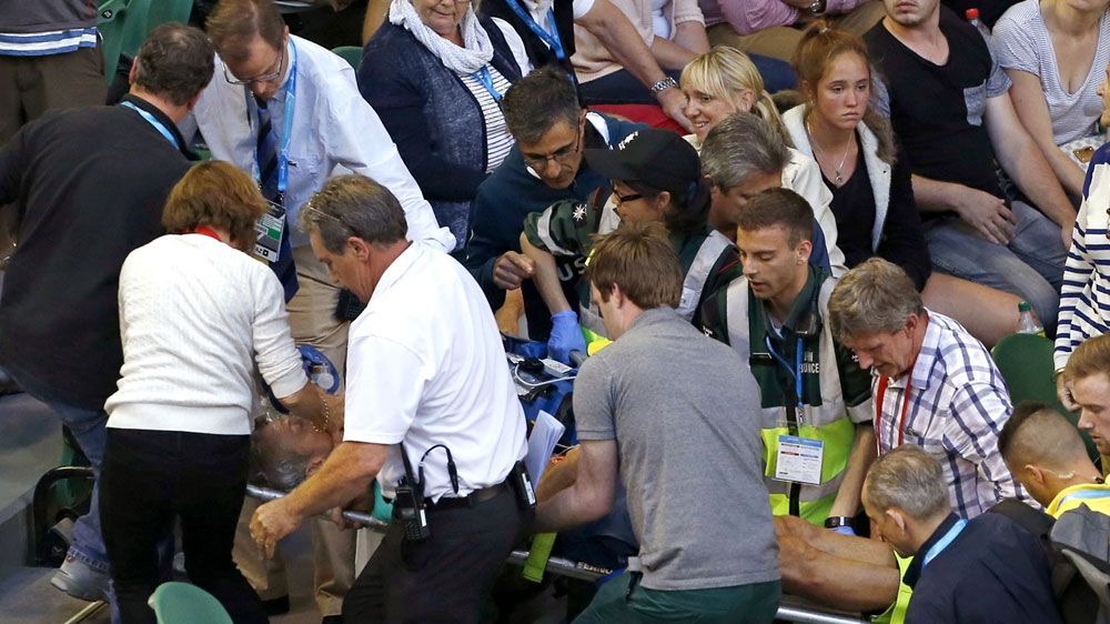Medics carry Nigel Sears from Rod Laver Arena (AAP)