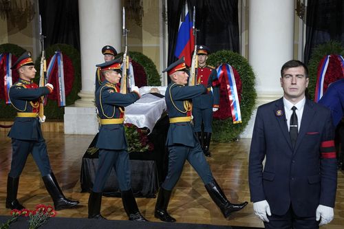 Honour guards march by the coffin of former Soviet President Mikhail Gorbachev inside the Pillar Hall of the House of the Unions during a farewell ceremony in Moscow, Russia, Saturday, Sept. 3, 2022.  