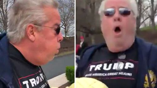 A man who deliberately breathed heavily on two protesters outside of President Donald Trump's golf course in Virginia has been charged with assault