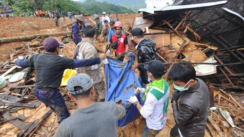 Hundreds of police, soldiers and residents dug through the debris with their bare hands, shovels and hoes as heavy rain hindered their efforts.
