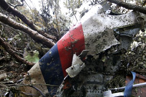 wreckage of a Sukhoi Super-jet 100 is seen at the crash site on Mount Salak , Bogor, West Java, Indonesia. Clearer weather finally allowed Indonesian helicopters to land Saturday and retrieve some remains of the 45 people aboard the Russian-made plane that crashed into the volcano during a demonstration flight. (AP Photo/Kusumadireza) 