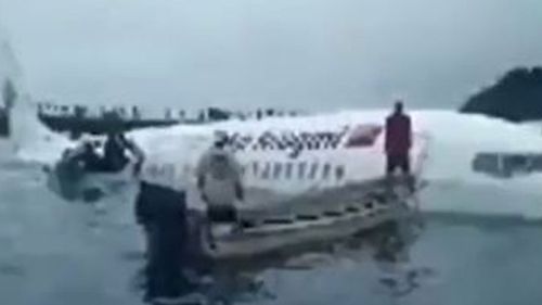 The plane in the ocean after overshooting the runway in Micronesia close to Papua New Guinea.