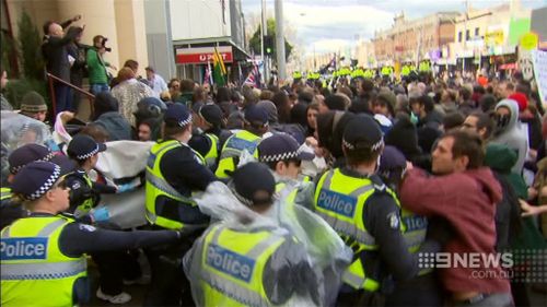 A number of times protesters from each side broke through the police barricade. (9NEWS)