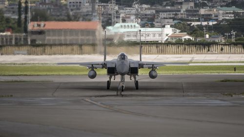 A US F-15 fighter plane taxis back to the hangar at Kadena Air Base, Japan, in 2017