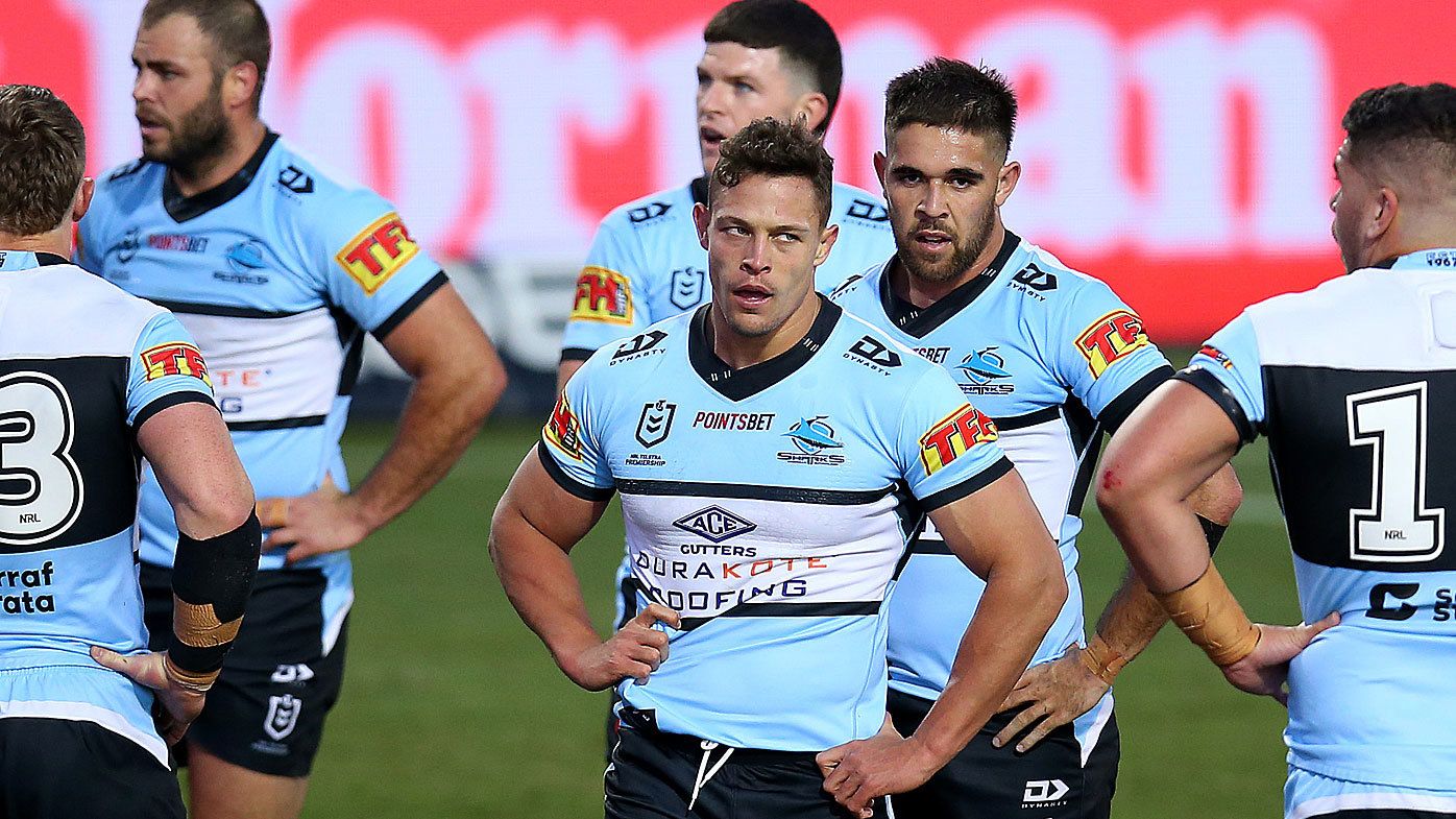 Sharks players react after a Dragons try during their loss