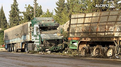 This image provided by the Syrian anti-government group Aleppo 24 news, shows damaged trucks carrying aid, in Aleppo, Syria. (AAP)