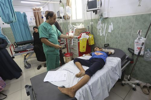 A Palestinian wounded in the Israeli bombardment of the Gaza Strip waits for treatment in a hospital in Rafah on Saturday, Oct. 28, 2023. 
