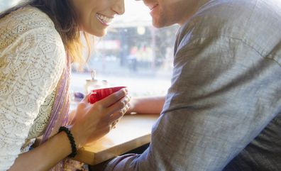 Couple holding hands in cafe