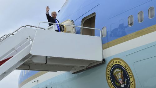 President Donald Trump walks up the steps of Air Force One at Andrews Air Force Base.